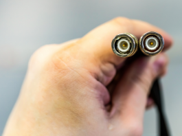 Hand holding rg and rg coax cables
