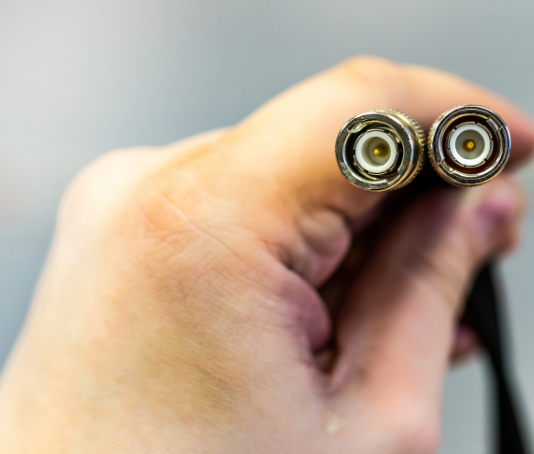 Hand holding rg and rg coax cables